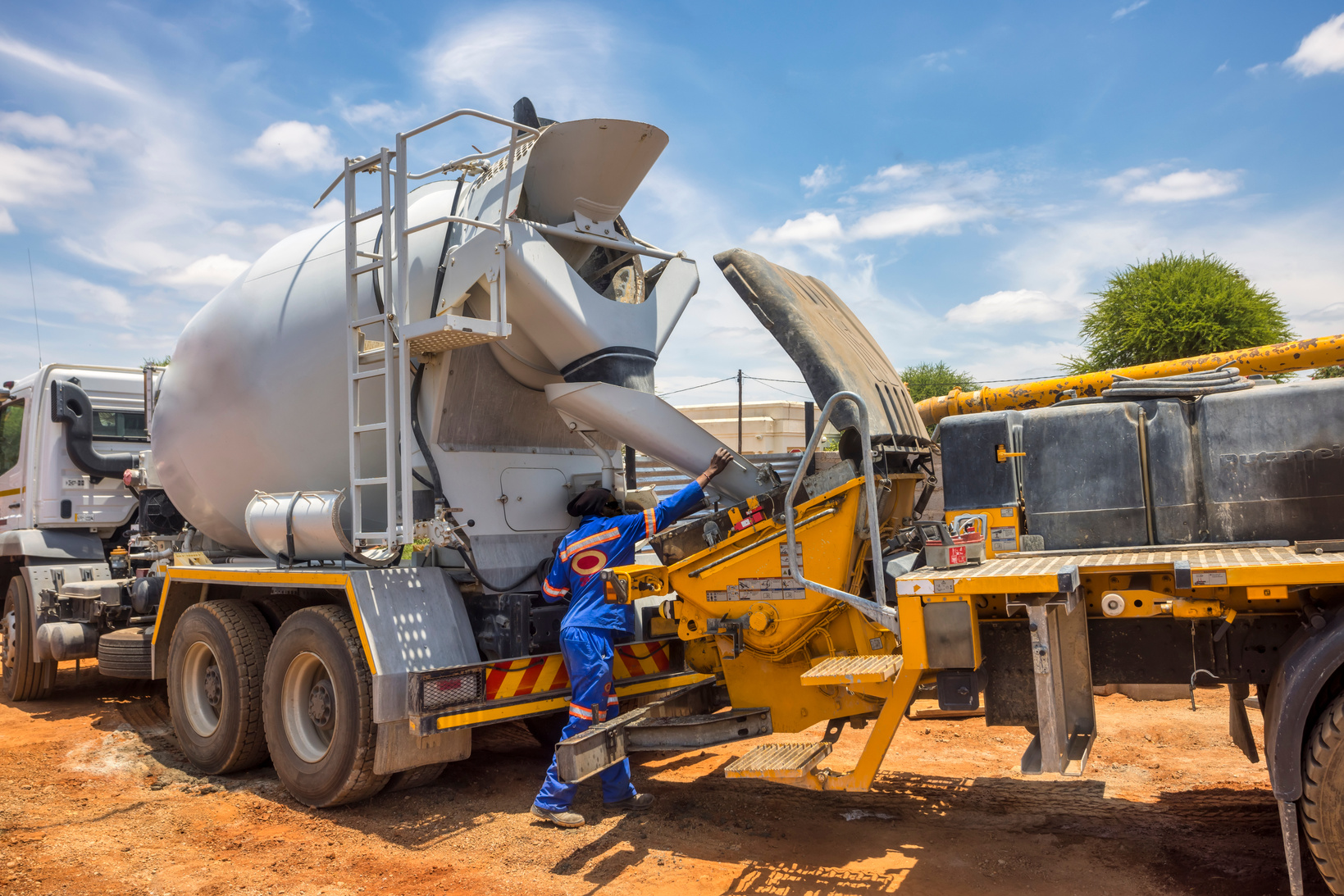 concrete mixer truck loading a boom concrete pump